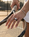 CAPITOLINE Flex Ring in Vesuvius Black, worn on the tennis court